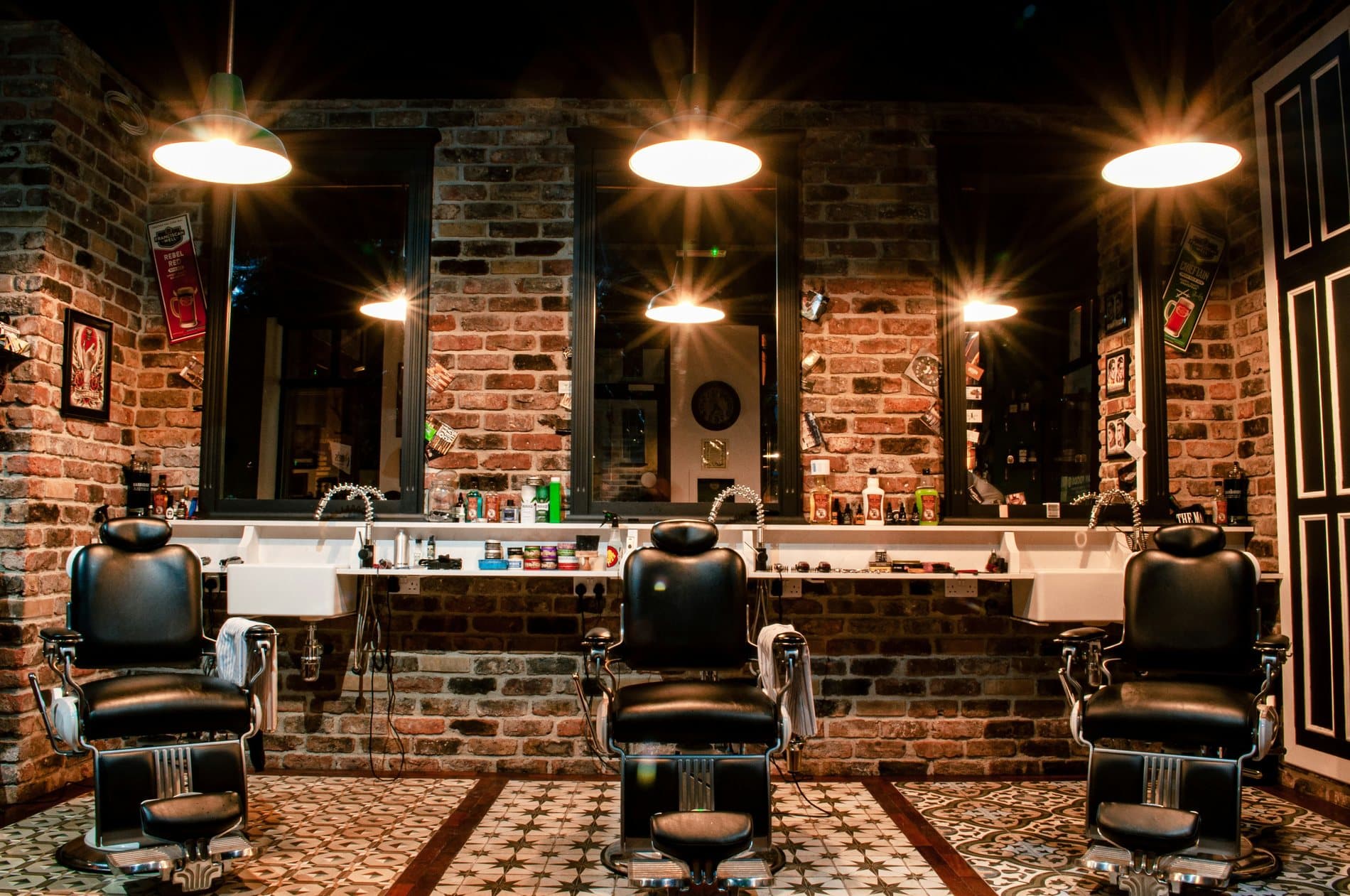 Vintage-style barbershop interior with exposed brick walls and classic barber chairs