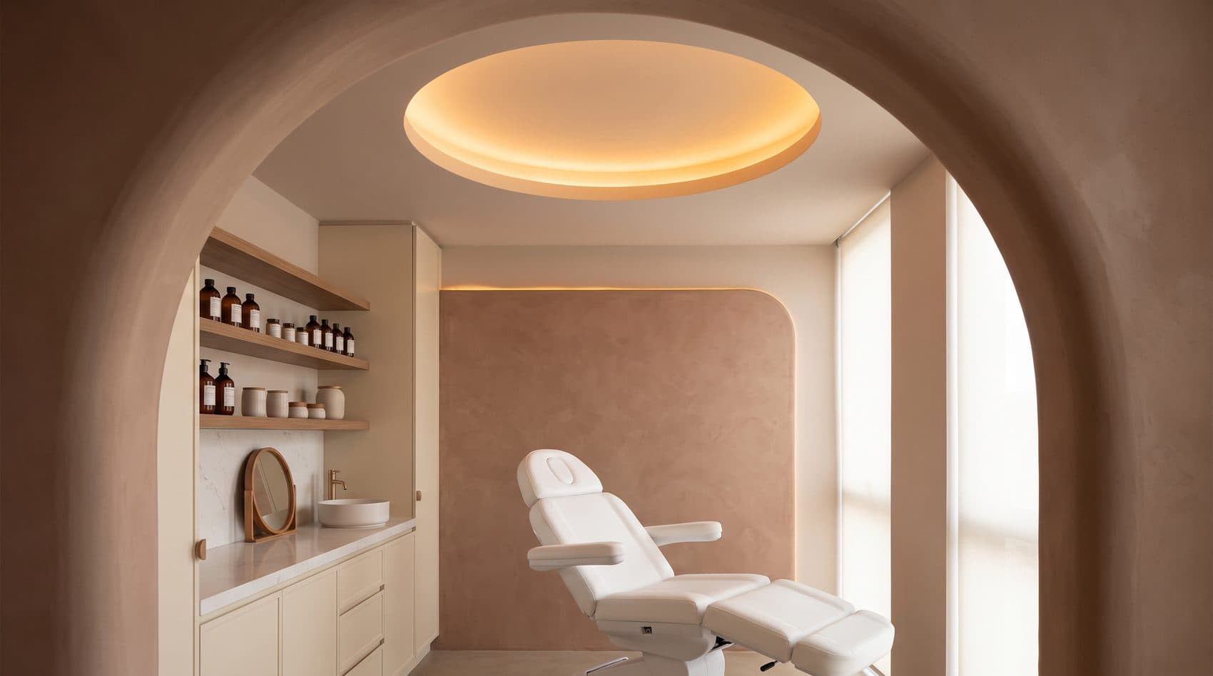 A contemporary HHI treatment room with a central procedure chair and shelving of hair and scalp care products